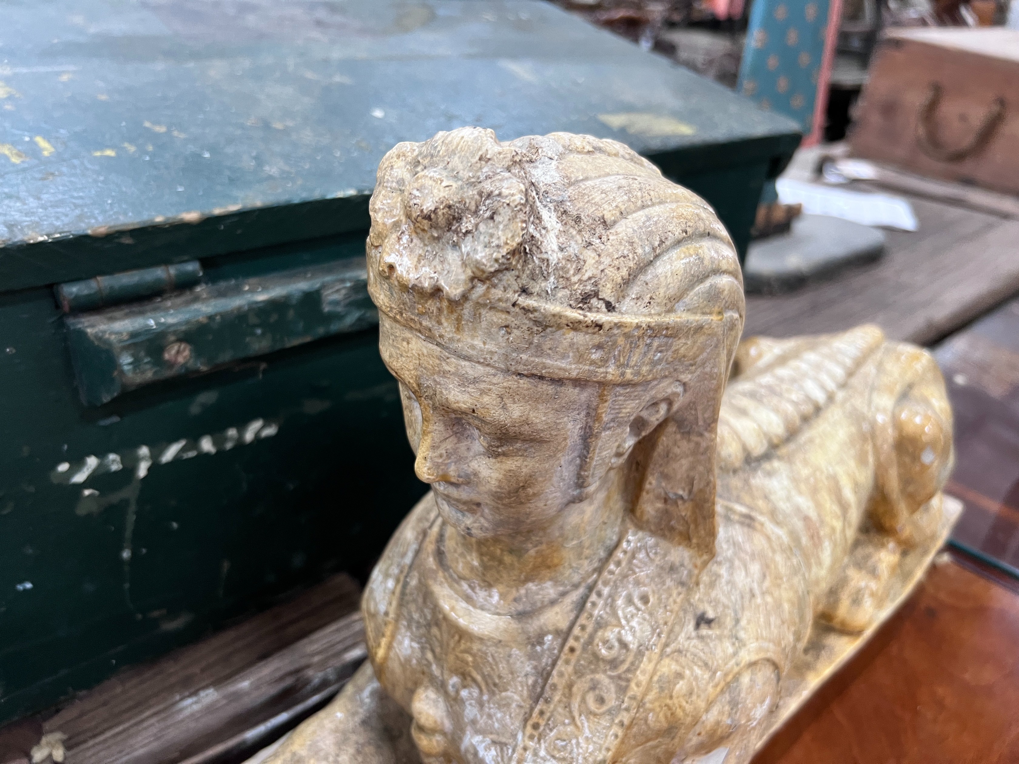 A pair of composition faux marble sphinx, length 48cm, height 30cm *Please note the sale commences at 9am.